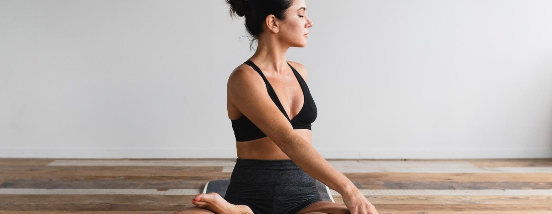 woman stretching on a yoga mat