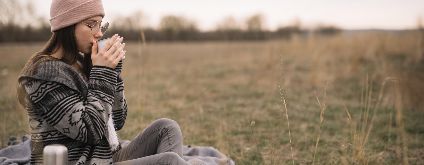 a woman sitting in a field